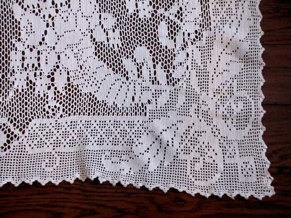 close up vintage handmade figural lace tablecloth