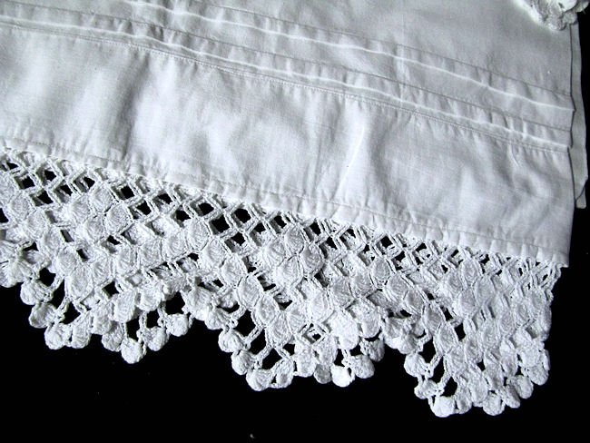close up handmade lace and pintucks on pair vintage pillowcases