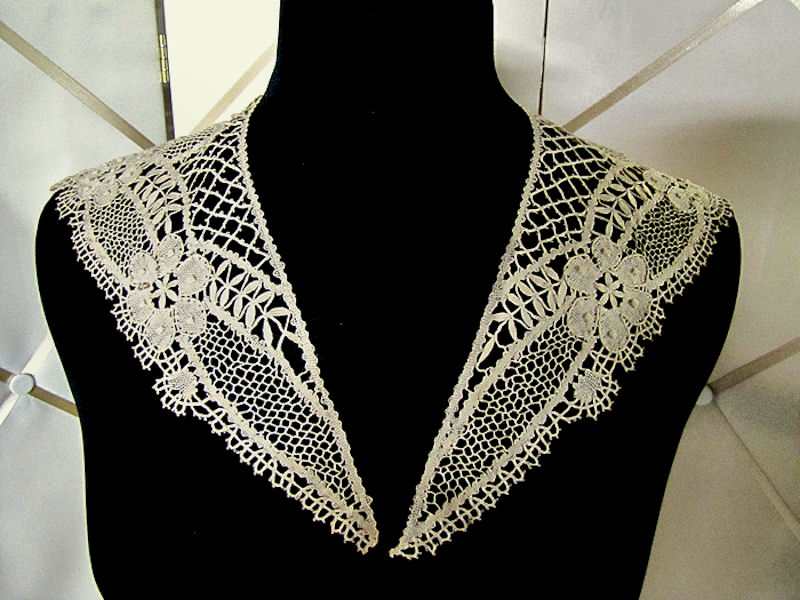 close up vintage antique figural lace collar