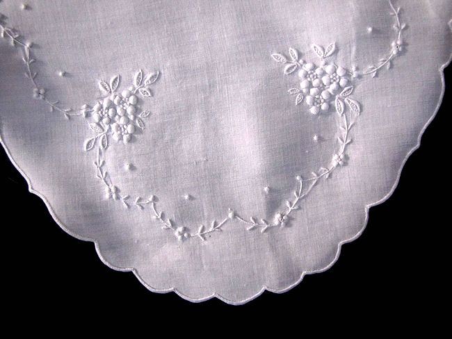 close up vintage white linen doily with handmade whitework