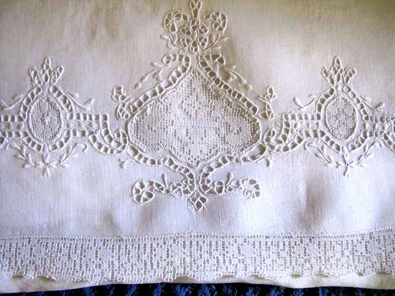 close up single vintage pillowcase with handmade lace and whitework