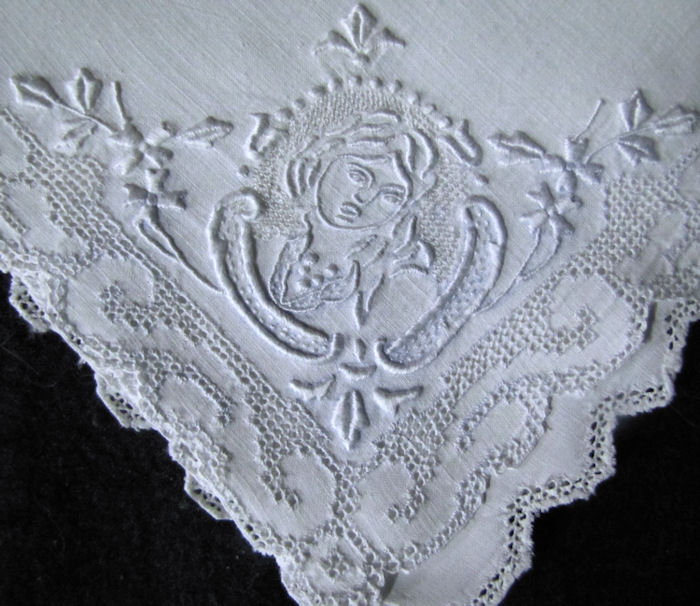 close up 2 figural Appenzell lace on white linen napkins