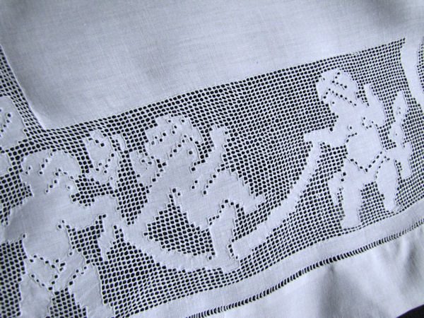 close up 2 figural lace cherubs on antique pillow sham