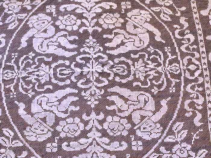 close up vintage antique handmade figural lace tablecloth