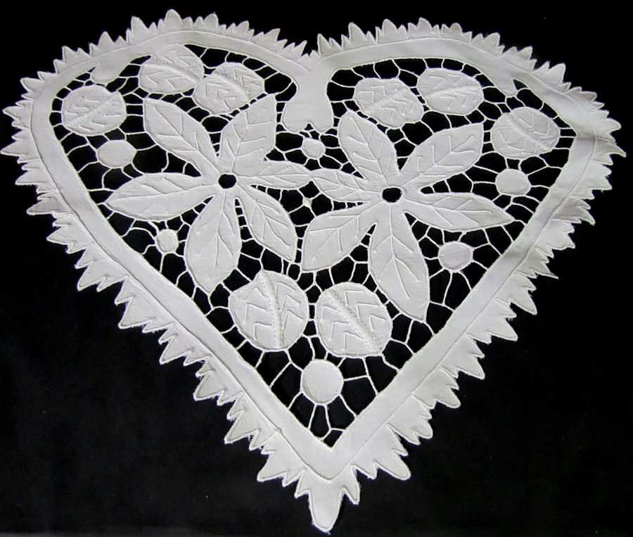 close up pair vintage antique heart shaped doilies with lace and whitework