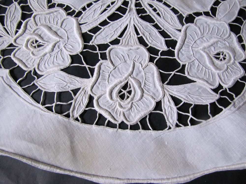 close up vintage white linen antique table topper handmade cutwork lace