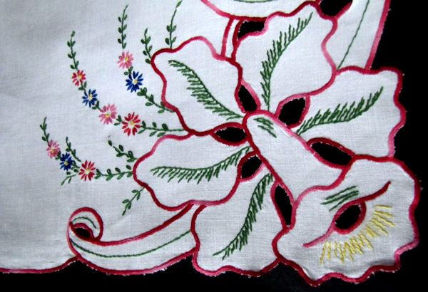 close up vintage linen table runner or dresser scarf with cutwork lace and vivid red embroidery