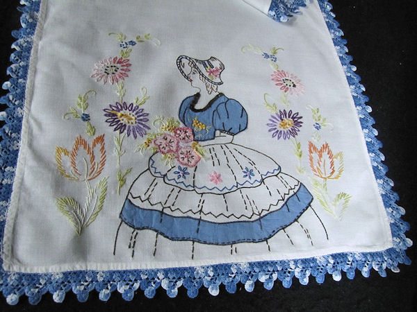 close up of southern belle on first table runner of 5 piece vintage dresser set