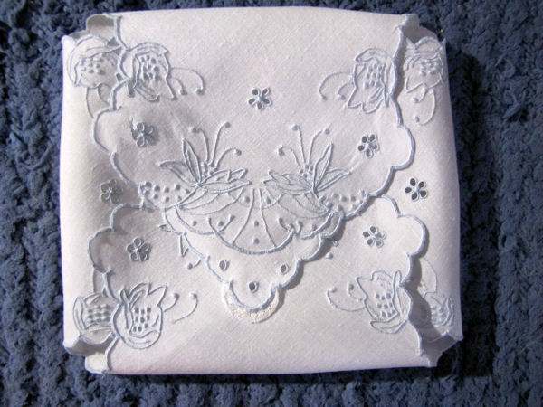 close up vintage white linen roll cover handmade Madeira lace and embroidery