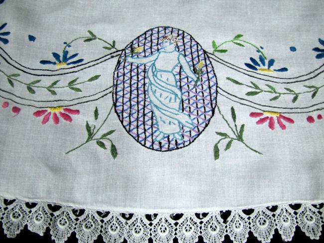 close up vintage antique white linen table topper with figural embroidery