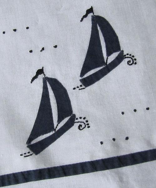 close up pair vintage handmade linen towels with sailboats
