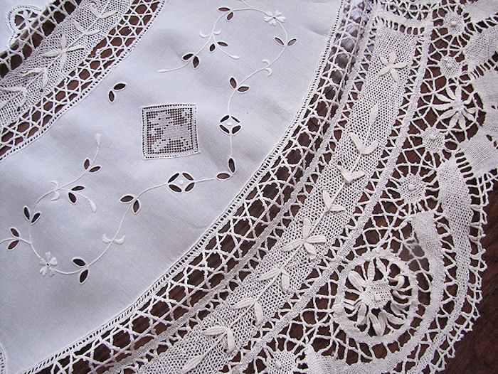 close up vintage antique handmade round tablecloth Cluny and figural lace