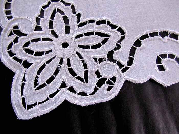 close up vintage antique table runner handmade lace and embroidery