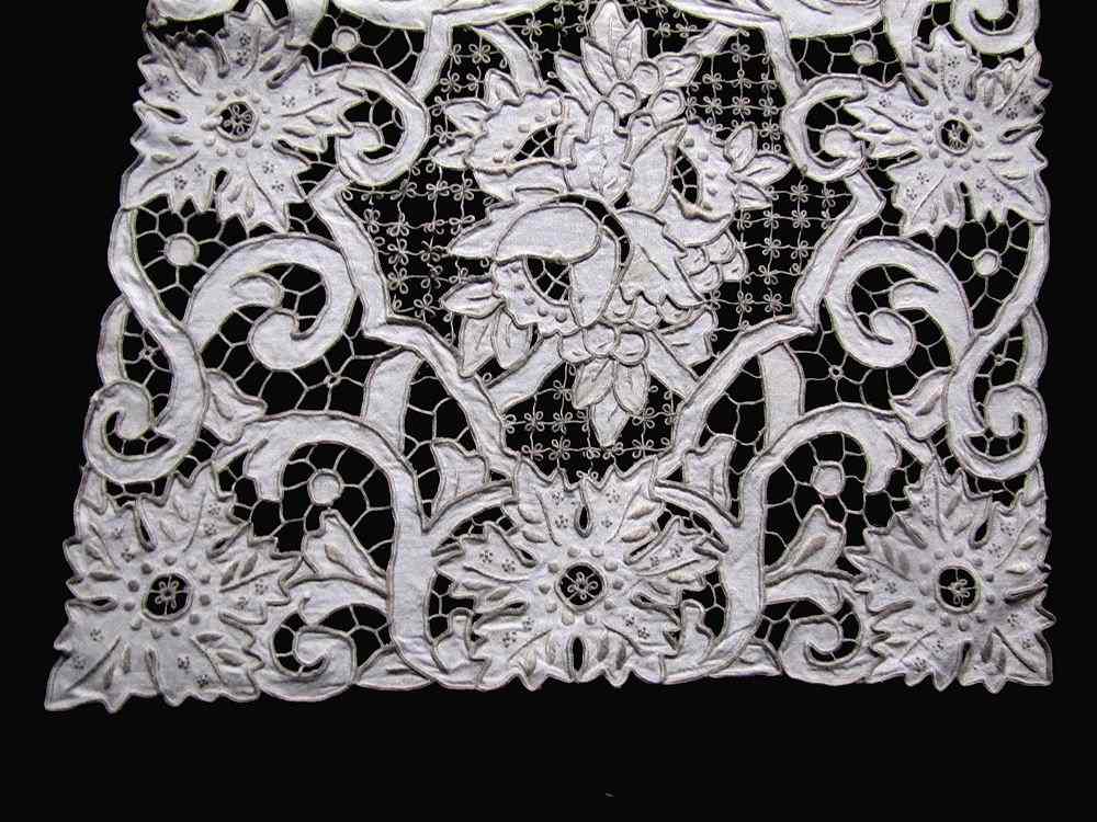 close up vintage antique table runner handmade lace and embroidery