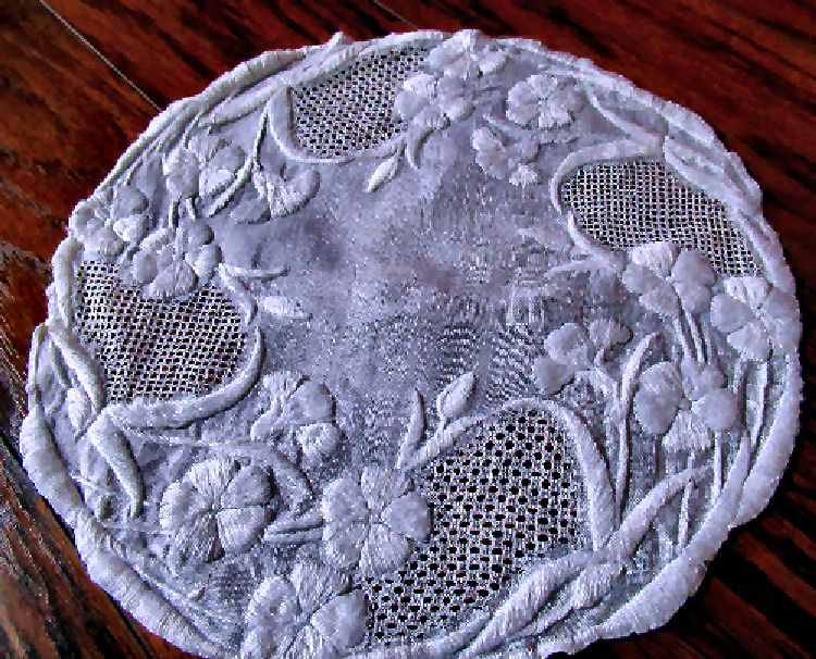 close up of single of a pair vintage  antique handmade doilies lace and whitework embroidery