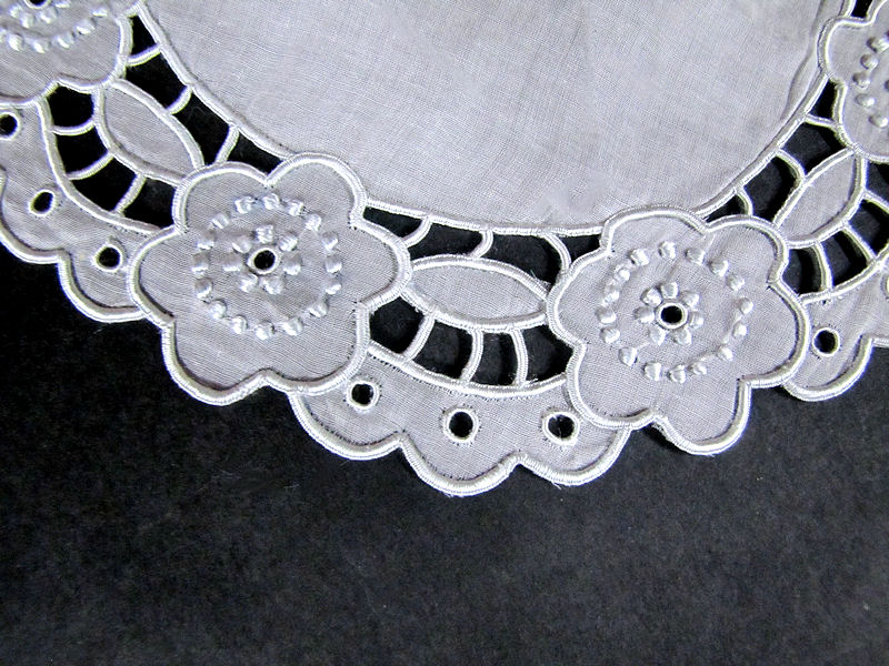 close up vintage antique doily set with cutwork lace