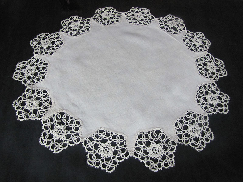 close up vintage antique table topper handmade tatted lace