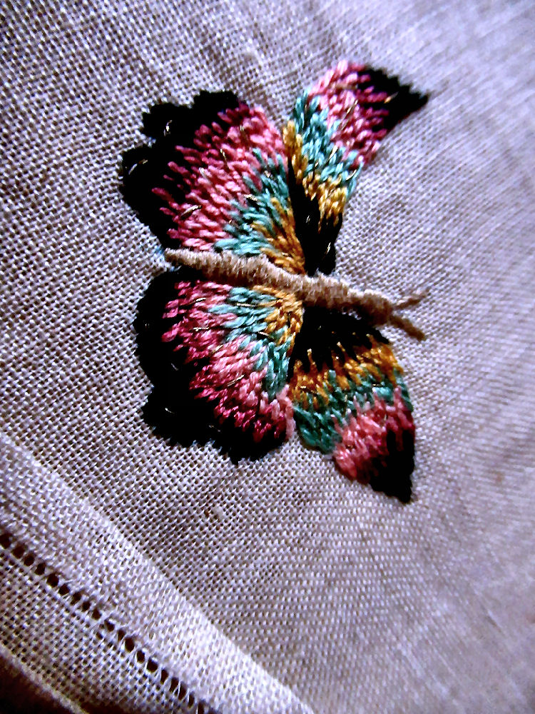 close up one vintage  antique linen  napkin hand embroidered Butterfly