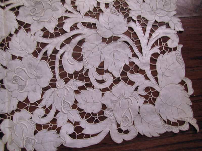 close up vintage antique white linen tablecloth handmade lace and embroidery