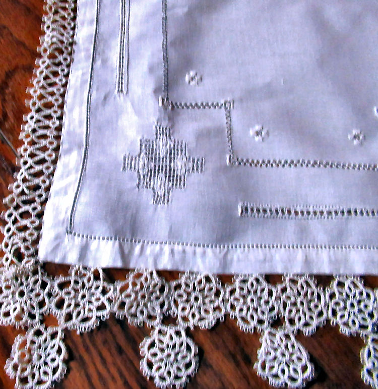 close up vintage  antique handmade table runner lace and embroidery