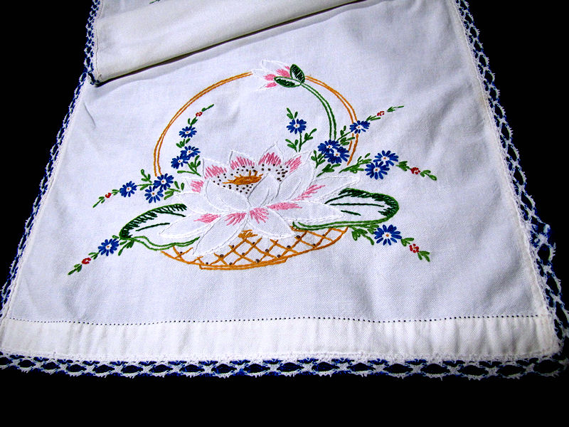 close up vintage table runner embroidered blue flower basket