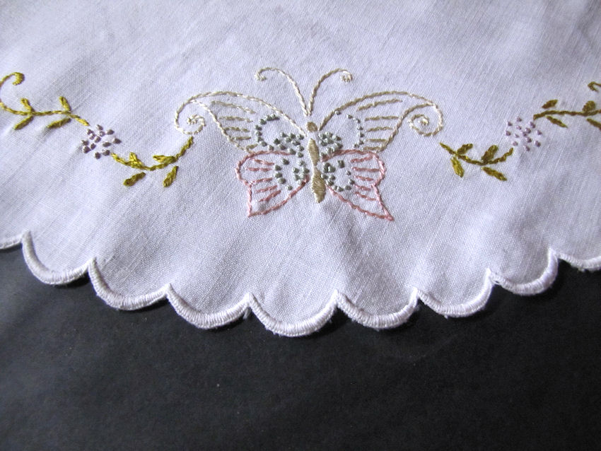 close up vintage antique table topper hand embroidered butterflies