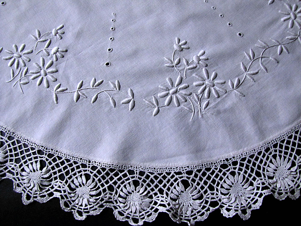 close up vintage antique table topper handmade lace and whitework