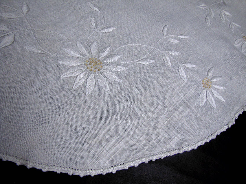close up vintage antique table topper hand embroidered daisies